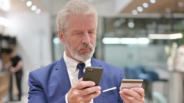 Senior Old Businessman Making Online Payment on Smartphone