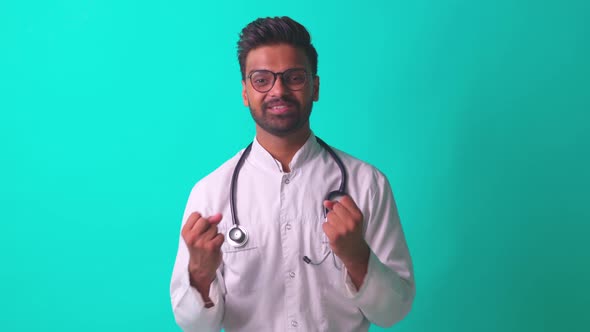 Indian Bearded Cardiologist Man with Eyes Glasses in White Medical Coat with Stethoscope in Blue