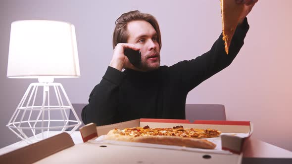 Young Caucasian Man Calling Pizzeria and Complaining About Pizza Delivery