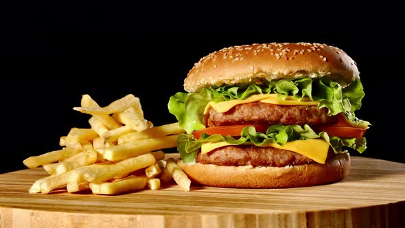 Craft Beef Burger and French Fries, Sauce Isolated on Black Background. Fast Food