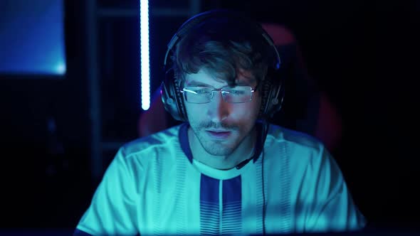 Portrait of a Angry Gamer in Headphones Plays a Video Game Cyber Sportsman at the International