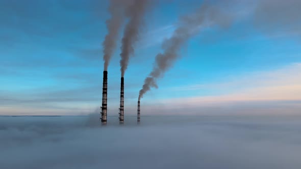 Aerial View of Coal Power Plant High Pipes with Black Smoke Moving Up Polluting Atmosphere at Sunset
