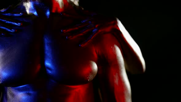 Closeup of a Muscular Male Torso with Golden Metallic Skin