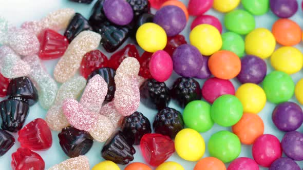 kid or woman adult hand taking one candy from a lot,stack of gummy bears,jelly candies