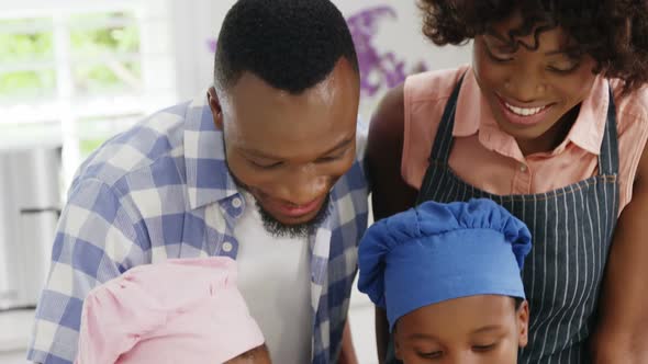 Happy family preparing food in kitchen