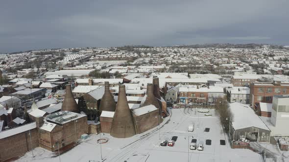 Aerial view of the famous bottle kilns at Gladstone Pottery Museum, covered in snow on a cold winter