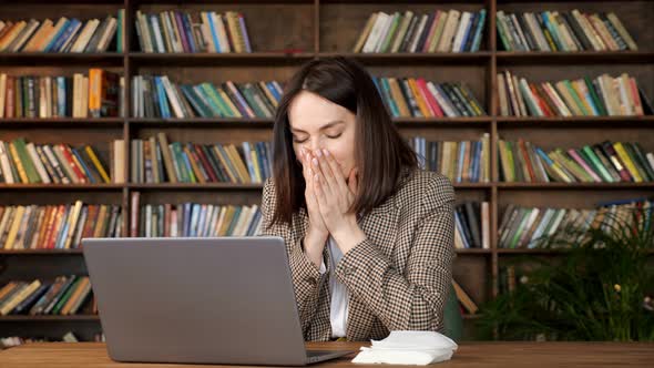 Young Woman with Short Loose Hair Sneezes and Takes Napkin