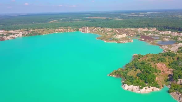 An artificial lake in chalk quarry. view from drone. Turquoise water background