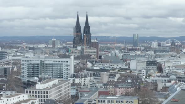 AERIAL: Wide Shot of Cologne Germany From the Air with Majestic Cathedral on Cloudy Day 