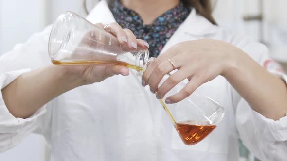 Female Scientist Analyzes Liquid in Distillery Laboratory Researcher. Slow Motion of Mixing