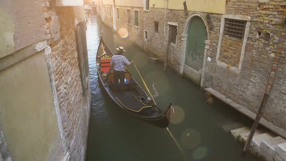 Experienced Gondolier Masterfully Guides His Ship Through Narrow Venice Streets