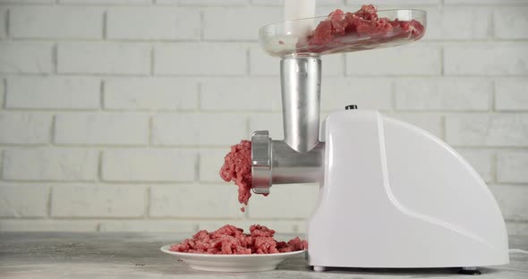 Cooking Raw Minced Meat at Home on a Meat Grinder.