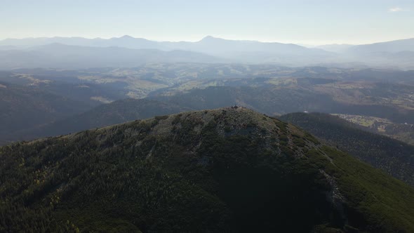 Aerial Landscape View of High Peaks with Dark Pine Forest Trees in Wild Mountains