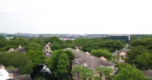 Private Villas Surrounded By Trees Near The Highway In Orlando, Florida. aerial drone forward