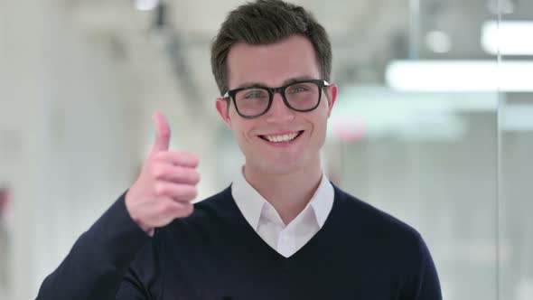 Positive Young Businessman Doing Thumbs Up