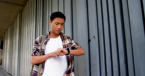 A man walking and using his smart watch