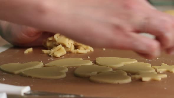 The Woman Works With The Rolled Dough. Cuts The Dough Into Heart Shaped Pieces.