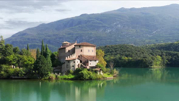 Aerial footage viewing a Castle at the lake with green water