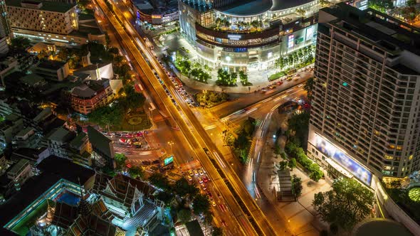 Bangkok business district city center above intersection and traffic, during night - Time Lapse