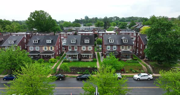 Aerial truck shot of city neighborhood on overcast spring day. American city suburb with small house