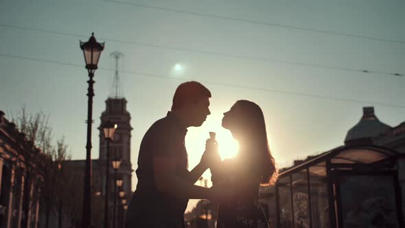 Happiness Couple with Ice Cream Under Sunlight. Sunrise at Morning.