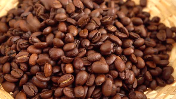 Falling coffee beans into a wicker basket. Slow motion.