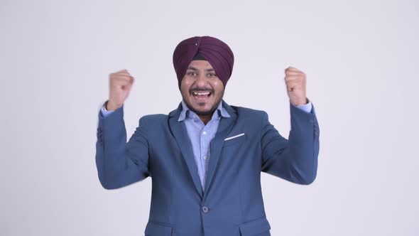 Happy Bearded Indian Sikh Businessman Getting Good News