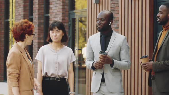 Multiethnic Business People Speaking on Street