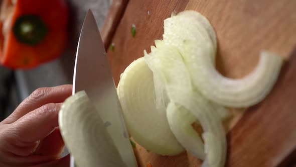 Vertical Shot Of A White Onion Chopped Using Sharp Knife At Home.