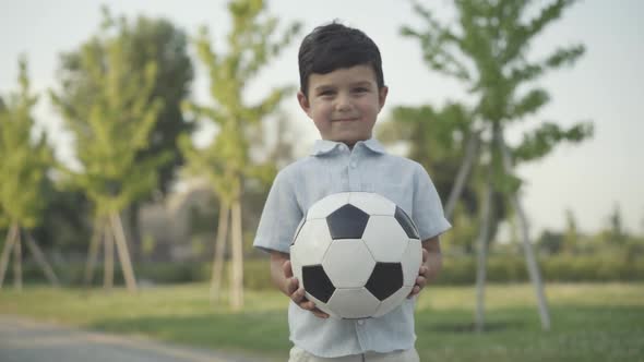 Happy Cute Smiling Boy Posing Ball Sunny Summer Park