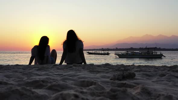 Beautiful ladies posing on paradise coastline beach trip by aqua blue ocean with bright sandy backgr