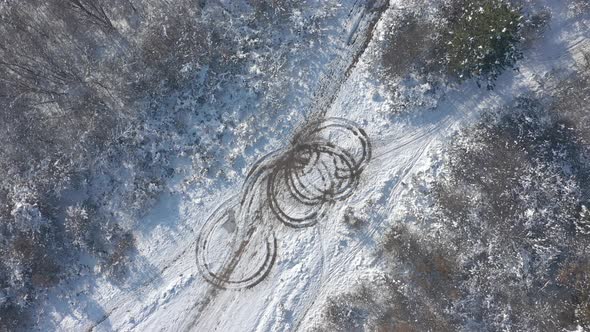 Car tire prints in the snow 4K aerial footage