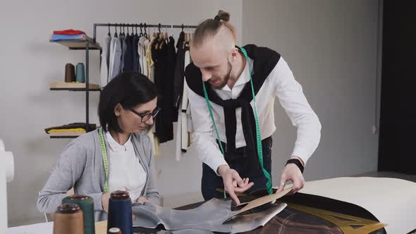 Two People Multi-ethnic Fashion Designers Working with Patterns 