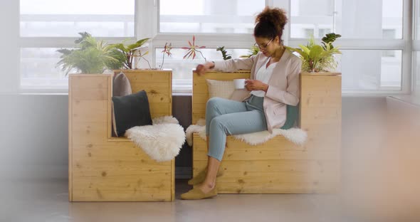 Businesswoman sitting on sustainable wood sofa for coffee