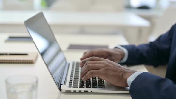 Side View of Hands of Businessman Typing on Laptop Close Up