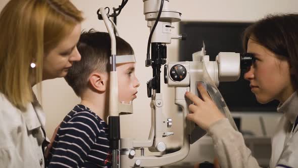 Optometrist Checks Kid's Vision Using Modern Opthalmology Medical Device