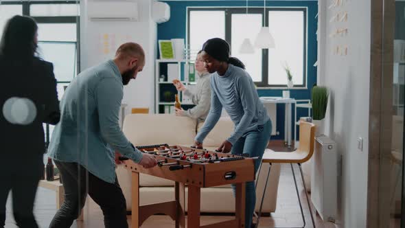 Man and Woman Playing Football Game at Foosball Table