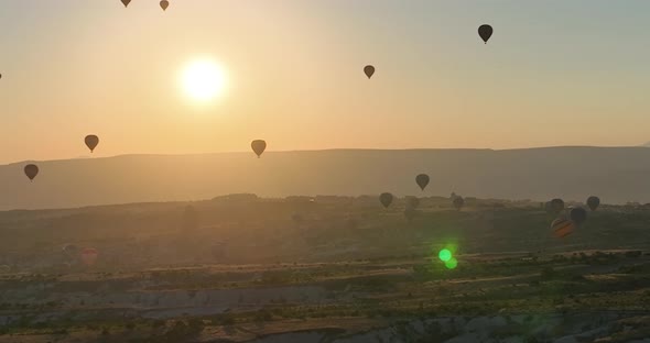 Aerial Cinematic Drone View of Colorful Hot Air Balloon Flying Over Cappadocia