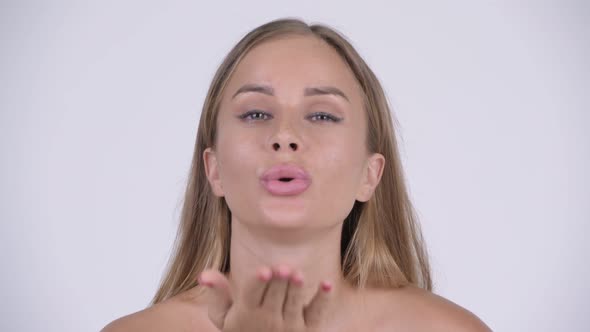 Face of Happy Young Beautiful Shirtless Blonde Woman Blowing Kiss