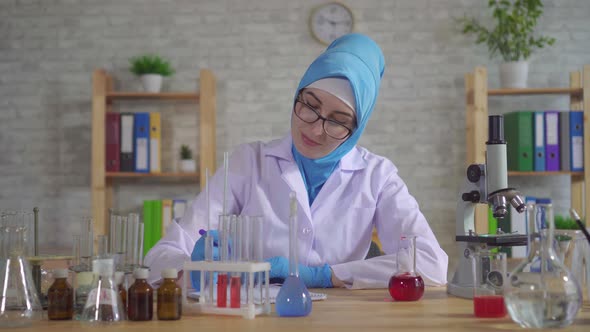 Portrait Young Muslim Woman Scientist Chemist in National Scarf Working in the Lab