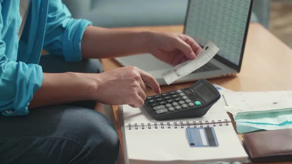 Close Up Of Man'S Hand Holding Bill And Calculating Money By Calculator