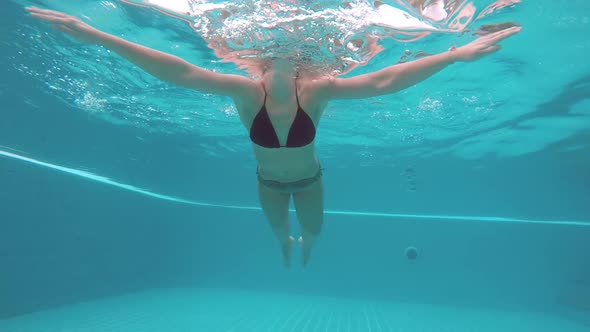 Underwater Shot of Woman Swimming Doing the Breastroke