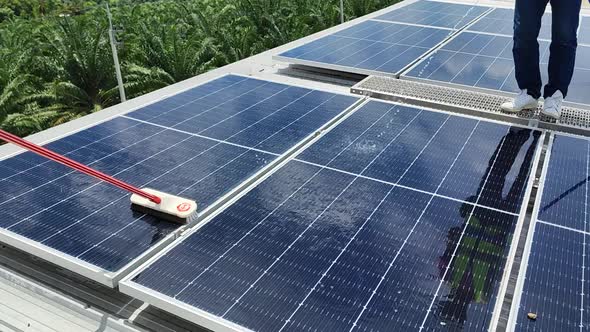 Technicians Cleaning and Maintaining Solar Panels alt