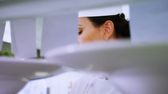 Female chef looking at an order list in the commercial kitchen 4k