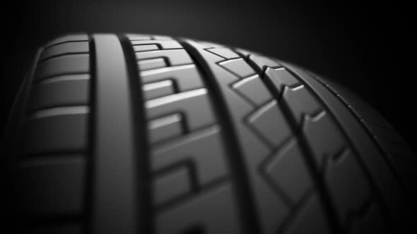 Endless slow-motion animation of a car tire spinning around. Loopable. HD