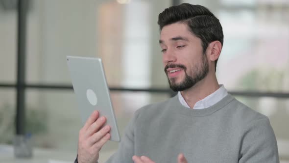 Portrait of Video Call on Tablet By Young Man in Office