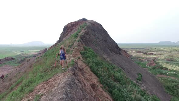 Young Woman Trekking along Mound Ridge