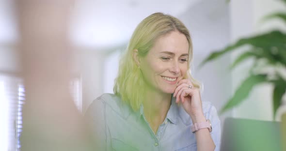 Working businesswoman looking at laptop