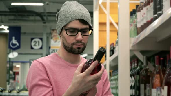 Man in Supermarket Chooses Wine