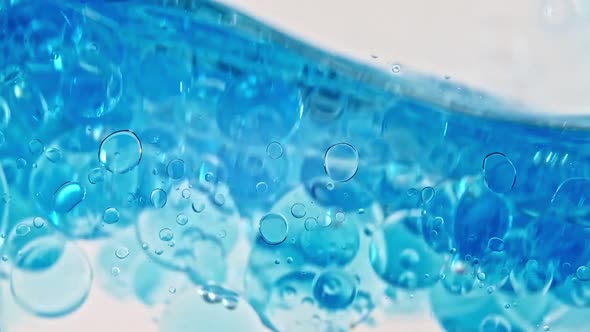 Blue Wave Water with Bubbles on White Background